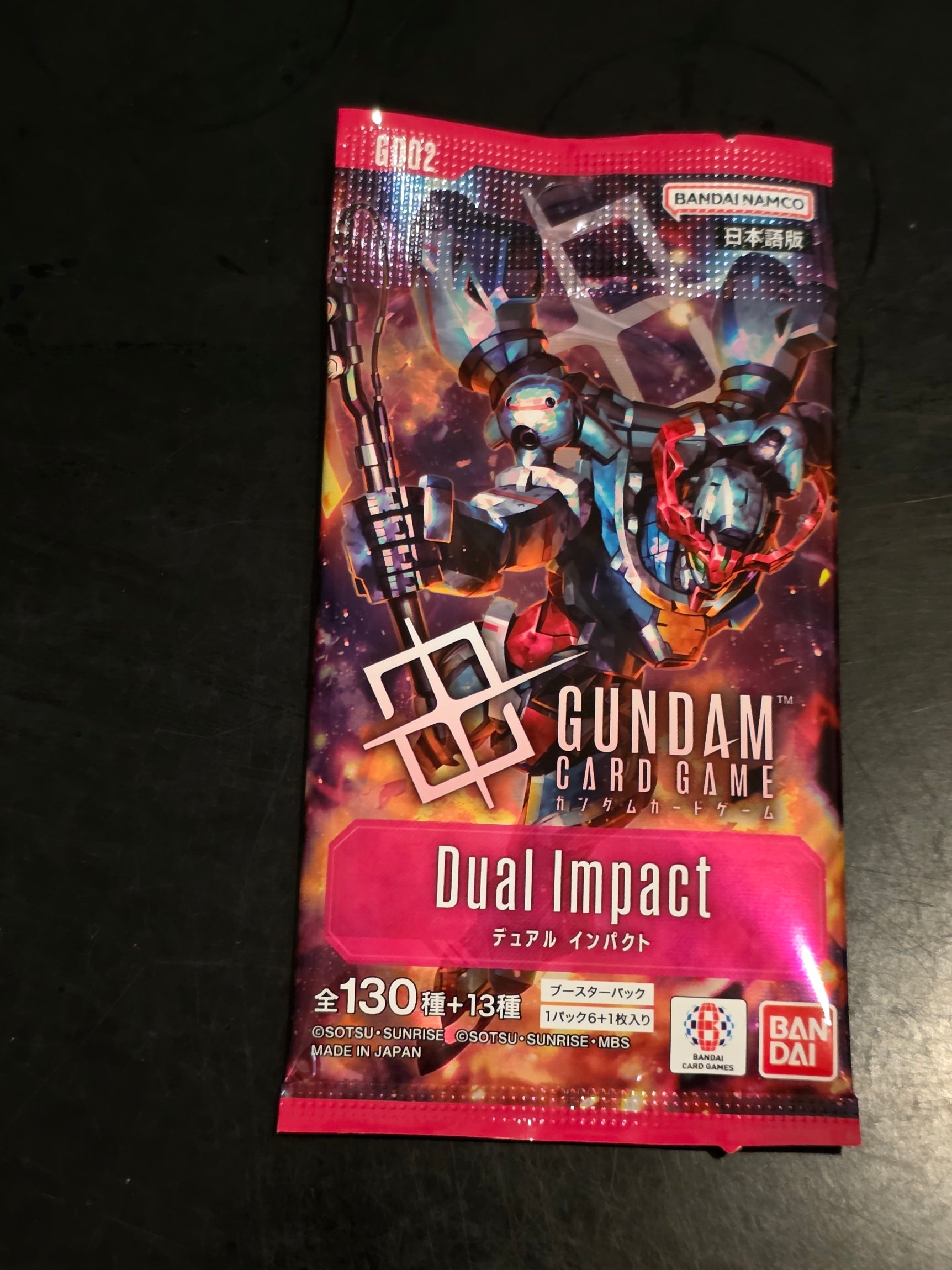 Gundam card game packaging with character illustration on a dark background